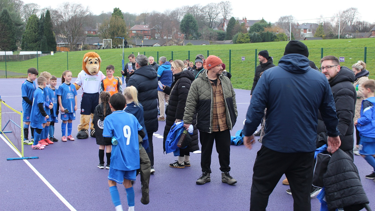 Bolton Wanderers mascot Lofty the Lion meeting young grassroots football players and families at the Coachathon event.