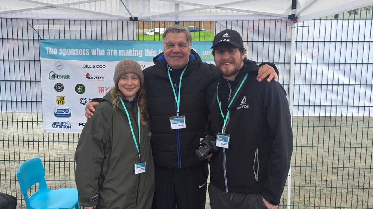 Former Premier League manager Sam Allardyce posing for a photo with two AIM-FOR team members at the Grassroots Coachathon.